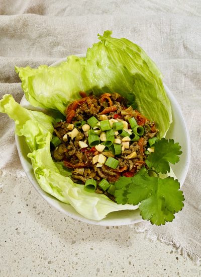 A plate of San Choy Bow - a mixture of Chinese spiced mince and vegetables served in a lettuce cup.